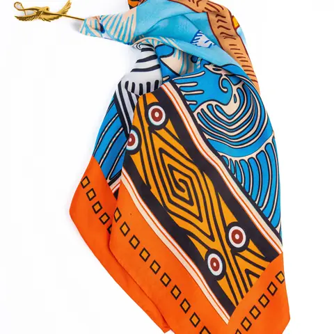 Foulard en soie à motifs géométriques orange et bleus.
